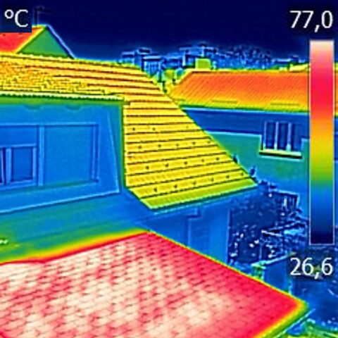 Infrared thermal image showing, warmed roofs on family homes