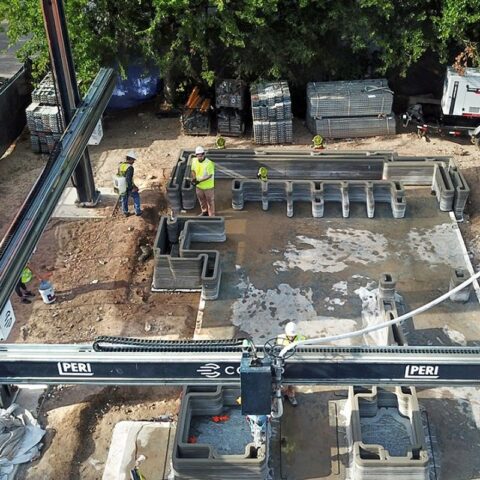 A construction 3D printer gantry is helping to build a Houston home that will be the first multistory 3D-printed structure in the U.S., also incorporating wood framing in a new hybrid design. (Lok/Zivkovic)